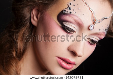 portrait of young woman with creative makeup face art
