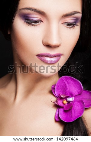 portrait of young sexy woman with orchid in hair
