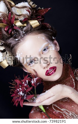 beautiful brunette with the creative hair-do uncommon makeup and the red lipstick