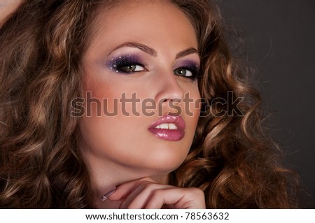 wonderful young woman with crown in the curly hair