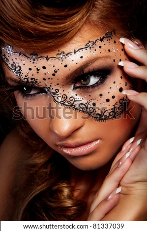 Pretty woman with creative makeup , mask on women\'s face