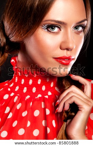 beautiful girl with two sexual plaits in the red blouse with the red chubby lips