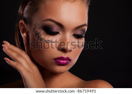 sexy young woman with mask on face and magnificent violet lips