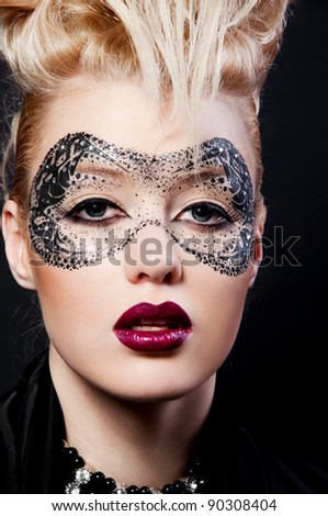 fashion photo of pretty blond woman with mask on face and creative hairstyle
