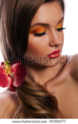 pretty woman with bright make up and orchid in the hair