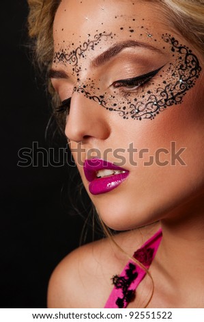 sexy woman with mask on face with creative face art