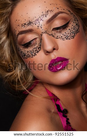 sexy woman with mask on face with creative face art