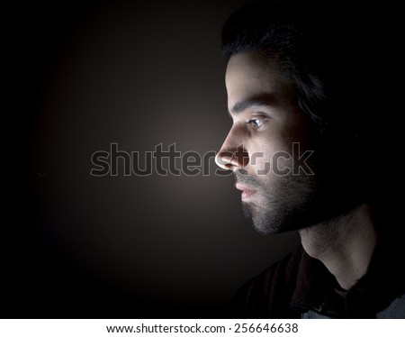 Dark portrait of a face in profile