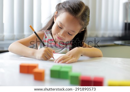 A little girl enjoying her learning at school - copy space available