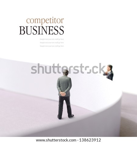 Business concept image depicting a competitor situation. Two businessmen divided by a wall. Copy space.