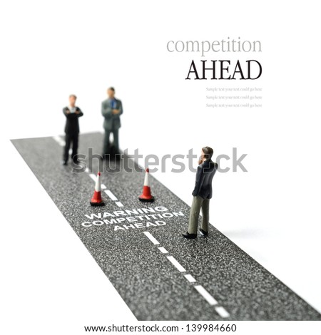 Business concept image depicting competitors waiting ahead. Selective focus on the road text. Copy space.