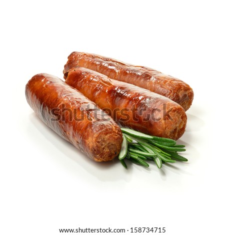 Studio Close Up Of Pin Sharp Focus Grilled Pork Sausages Stacked Against A White Surface With Rosemary Sprigs And Soft Shadows. Copy Space.