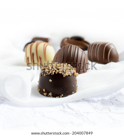 Close up of decadent Belgium chocolates on a light background. Copy space.