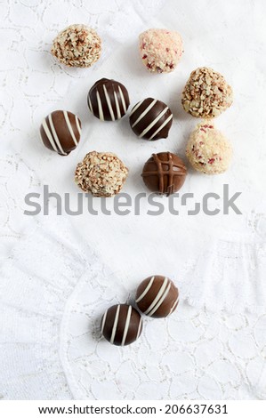 Aerial image of Belgium chocolates on white lace. Copy space.
