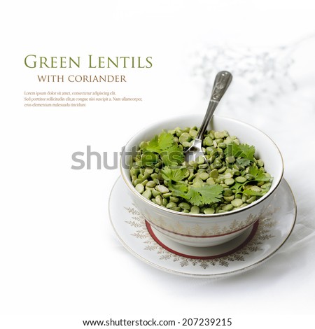 Green lentils and coriander leaves in a dish prepared for cooking. Copy space.