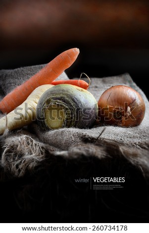 Selection of winter root vegetables lying on hessian against a rustic background with copy space. Shot in diffused natural light. Concept image for healthy eating or vegetarianism.