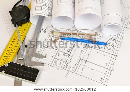 Construction drawings, tape measure, caliper, drills, pen and glasses. Desk builder