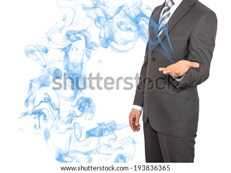Businessman in a suit holds smoke. The technology concept
