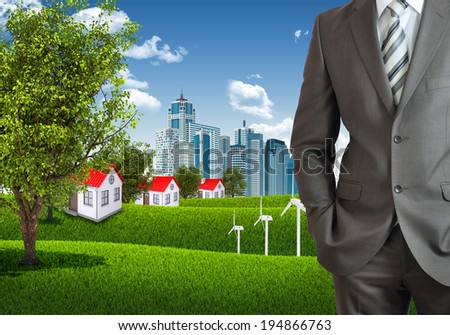 Businessman standing with hands in pockets. Urban scene as backdrop