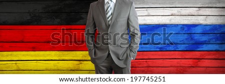 Businessman in a suit. Germany and Russian flags as background. Concept of business