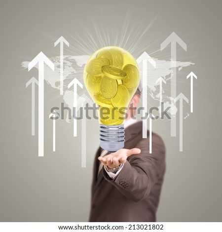 Businessman in a suit hold bulb with gold coins