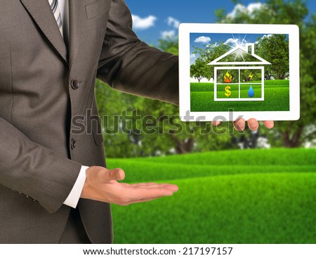 Two hands using tablet pc with picture of house icon