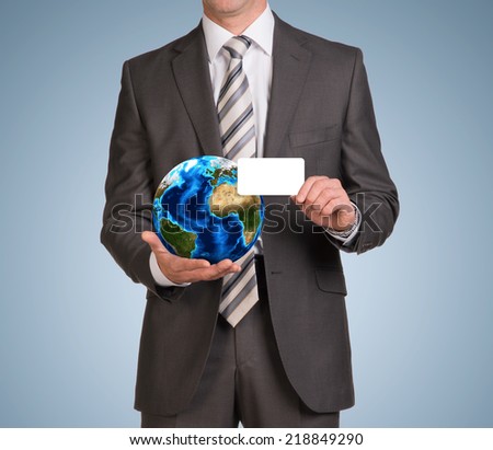 Businessman in suit hold empty card and Earth