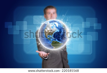 Businessman in suit hold Earth with transparent rectangles. Elements of this image are furnished by NASA