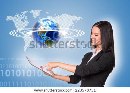 Beautiful businesswoman in suit using tablet and Earth, world map with figures on blue background. Element of this image furnished by NASA