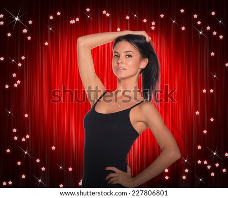 Beautiful dancer in black dress. Red curtain as backdrop