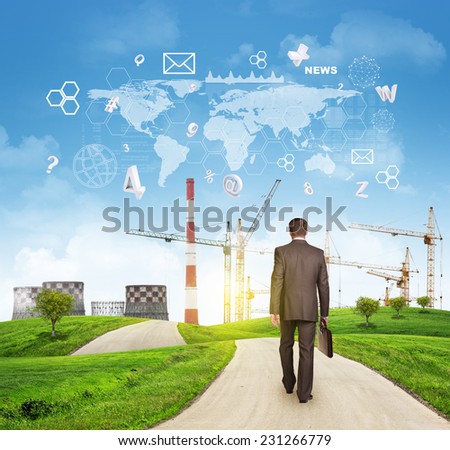 Businessman walks on road. Rear view. Industrial zone, grass field and sky with virtual elements. Business concept