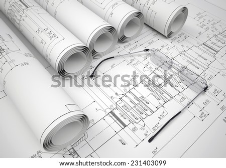 Scrolls of engineering drawings and glasses on drawing. Industrial concept