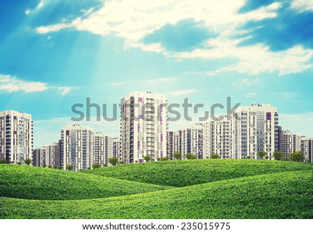 high-rise buildings of same design over green hills with low trees
