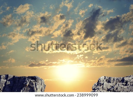 Gap in rocky pathway or chasm between two rocks. Sunrise sky as backdrop