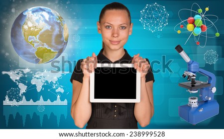 Beautiful businesswoman holding blank tablet PC. Atom model and microscope beside. Globe, world map with communication lines and geometric forms as backdrop.Elements of this image furnished by NASA