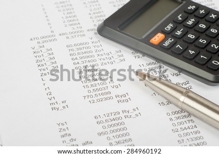 Documents with numbers and pen, calculator, close-up view