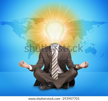 Businessman sitting in lotus posture with bulb instead head on abstract blue background with world map
