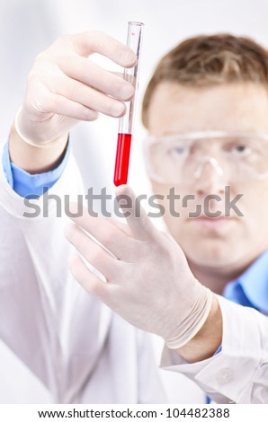 Man in white coat  with laboratory test tube