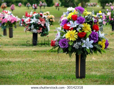 stock photo colorful silk flower vases in summer cemetery