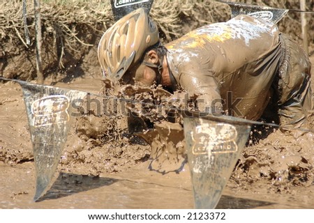 man going through mud pit