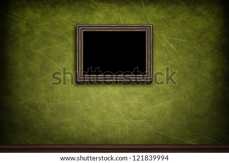 Old wooden frame on green retro grunge wall