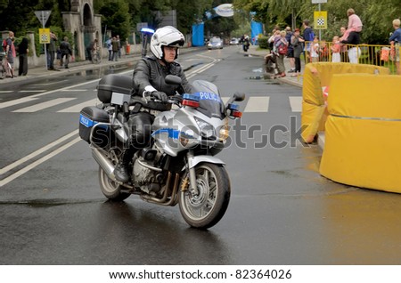 KATOWICE, POLAND - AUGUST 2: 68 Tour de Pologne, the biggest cycling event in Eastern Europe, policeman on motorbike of 3rd stage from Bedzin to Katowice August 2, 2011 in Katowice, Poland