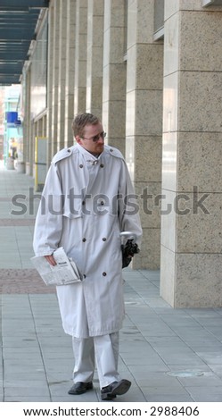 Young businessman wandering through the city, looking for work