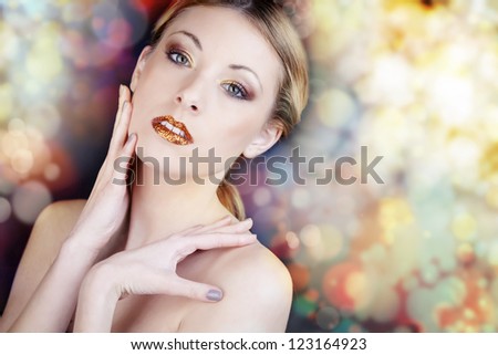 Blonde girl with glitter lips on abstract background