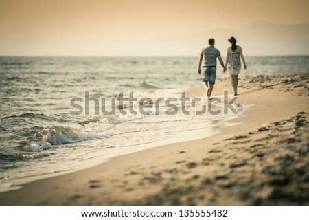 Couple Lovers walking on the beach