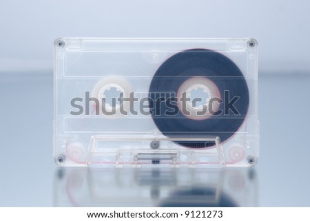 Old-fashioned cheap audio compact cassette on mirror