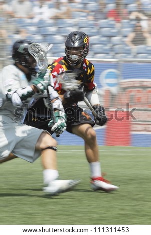 FOXBOROUGH - 28 MAY: A University of Maryland, College Park, player defends the net against a Loyola University Maryland, player at the NCAA Men\'s Division 1 Lacrosse Championship game, 28 May 2012 in Foxborough, Massachusetts