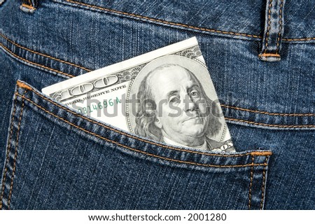 one hundred dollars banknote in hip-pocket of jeans, close up