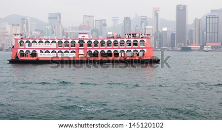 HONG KONG - MARCH 15: Tourist sightseeing cruise ship sails in Victoria Harbour, Hong Kong on March 15th, 2013