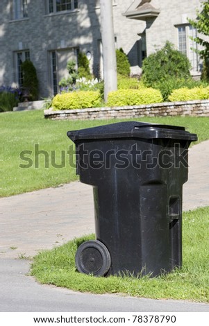 Improperly positioned wheeled garbage can curbside